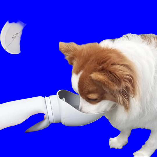 A dog water fountain adapter being used outdoors, with a white dog drinking from the spout held by a human hand. The image includes an inset diagram showing the sink dimensions and text stating it fits multi-sized dogs and brings more comfortable drinking.